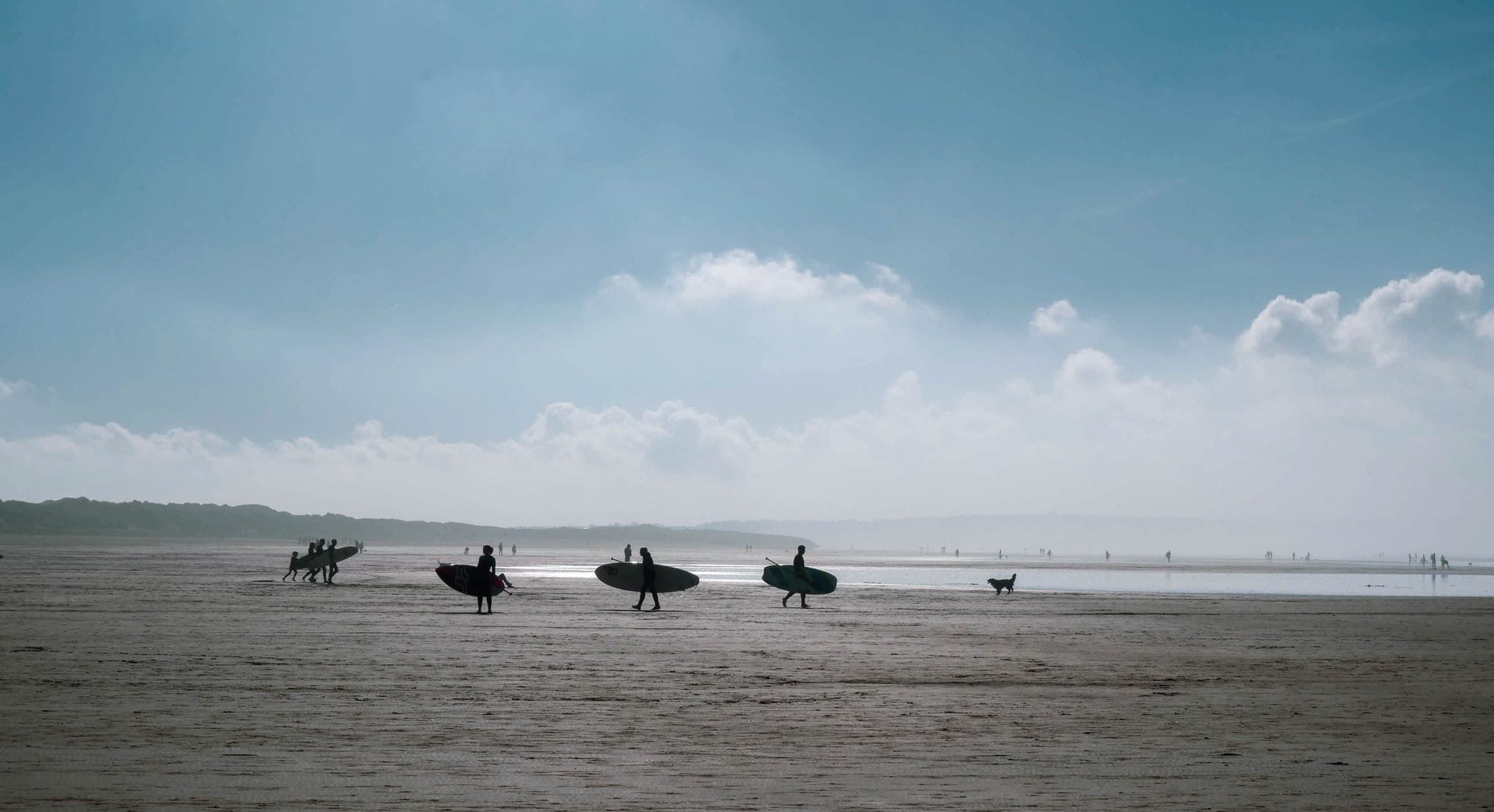 Surfers Walking On Saunton Sands